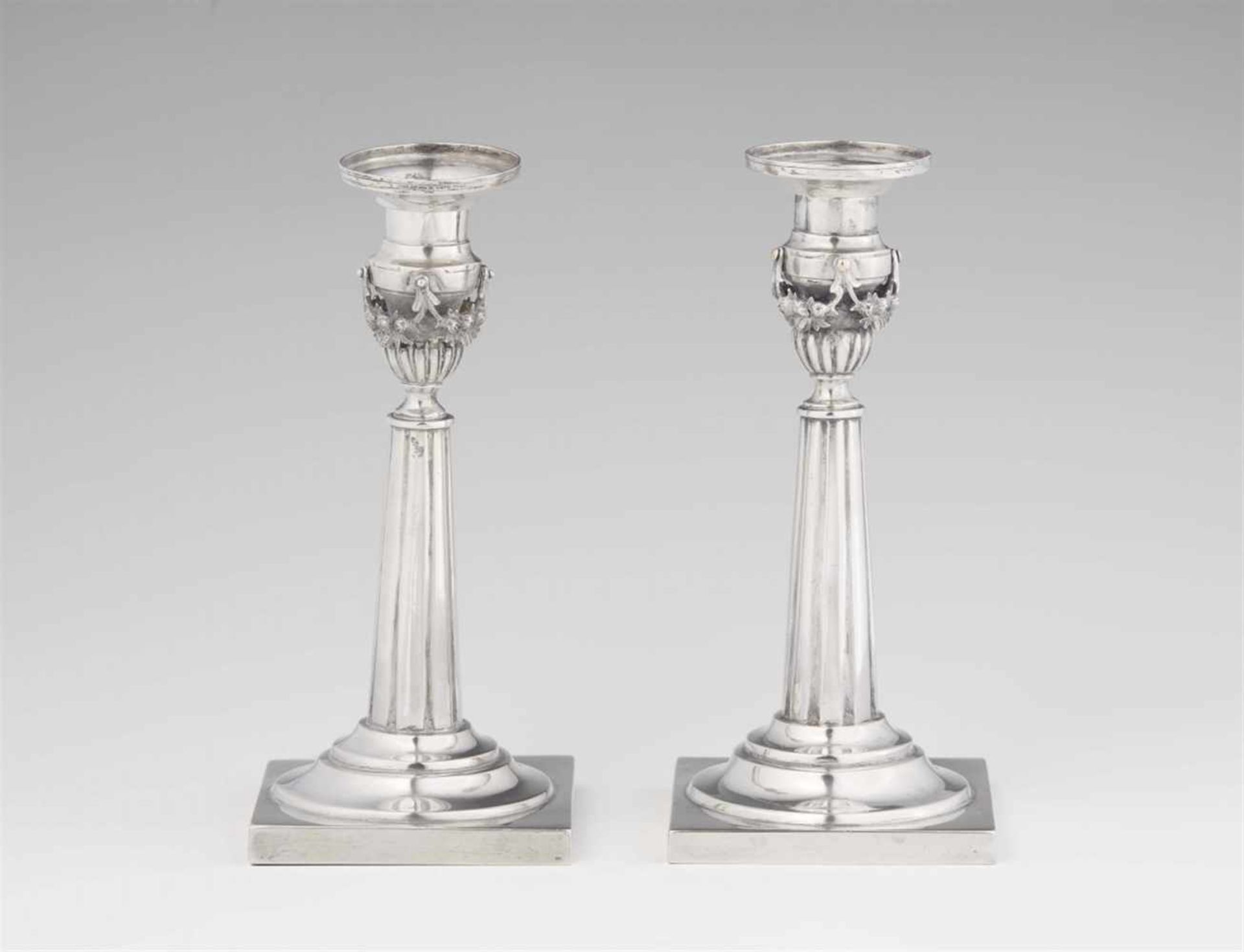 A pair of Weißenfels silver candlesticksTapering fluted shafts resting on square plinths. H 18 cm,