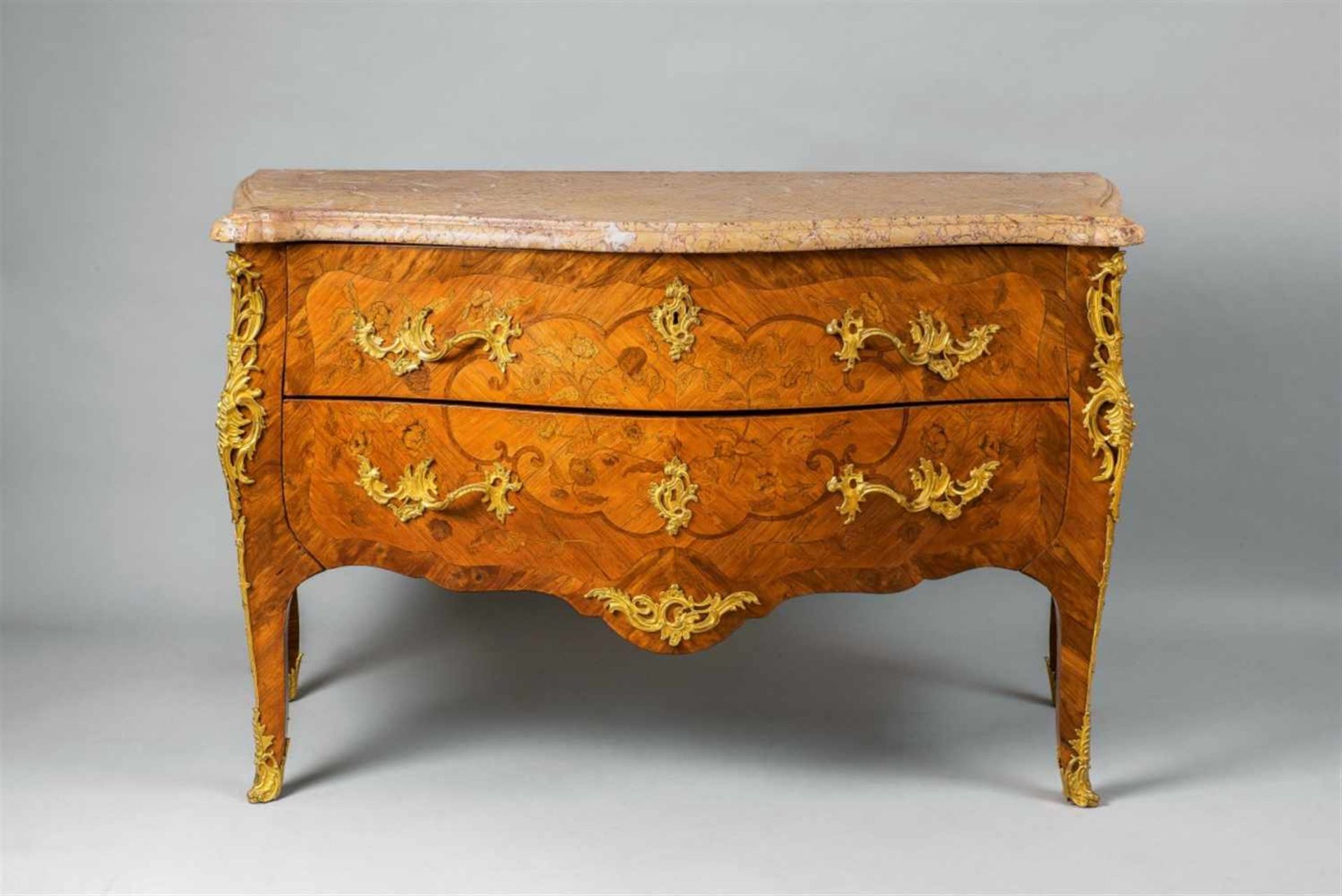 A Louis XV inlaid chest of drawersWalnut, rosewood, maple and stained woods on oak corpus, ormolu-