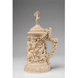 A magnificent German ivory tankard with the triumph of BacchusCarved in the round and with wooden