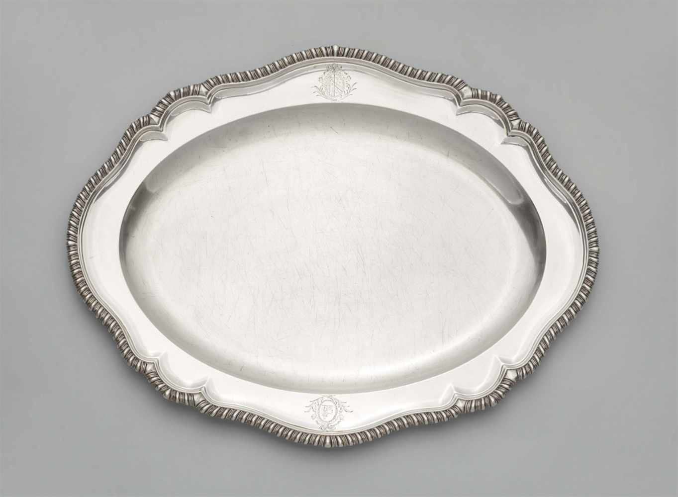 A large George III silver meat platterOval scalloped platter with gadrooned rim, engraved to the