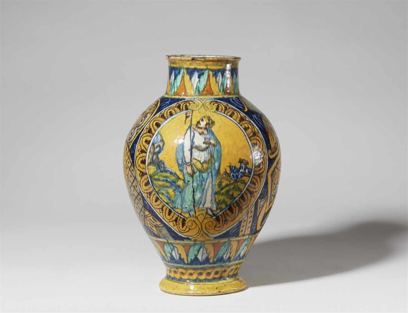 A Sicilian majolica apothecary vaseBaluster form albarello with depictions of Christ in scrollwork