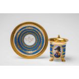 A porcelain cup with a portrait of Count Friedrich von FranquemontCylindrical cup resting on pad