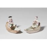 A pair of Strasbourg faience condiment dishes with figuresA rustic gentleman and a lady seated on