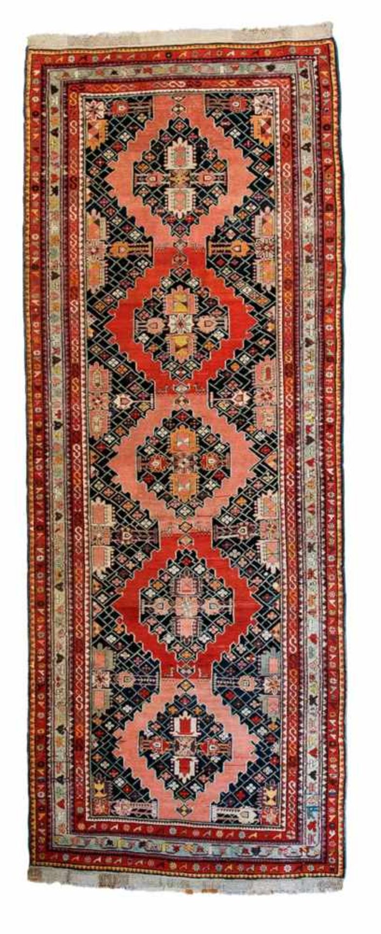 A Karabakh carpetWool. Repairs, some over creases. 344 x 131 cm. Armenia / Azerbaijan, late 19th /