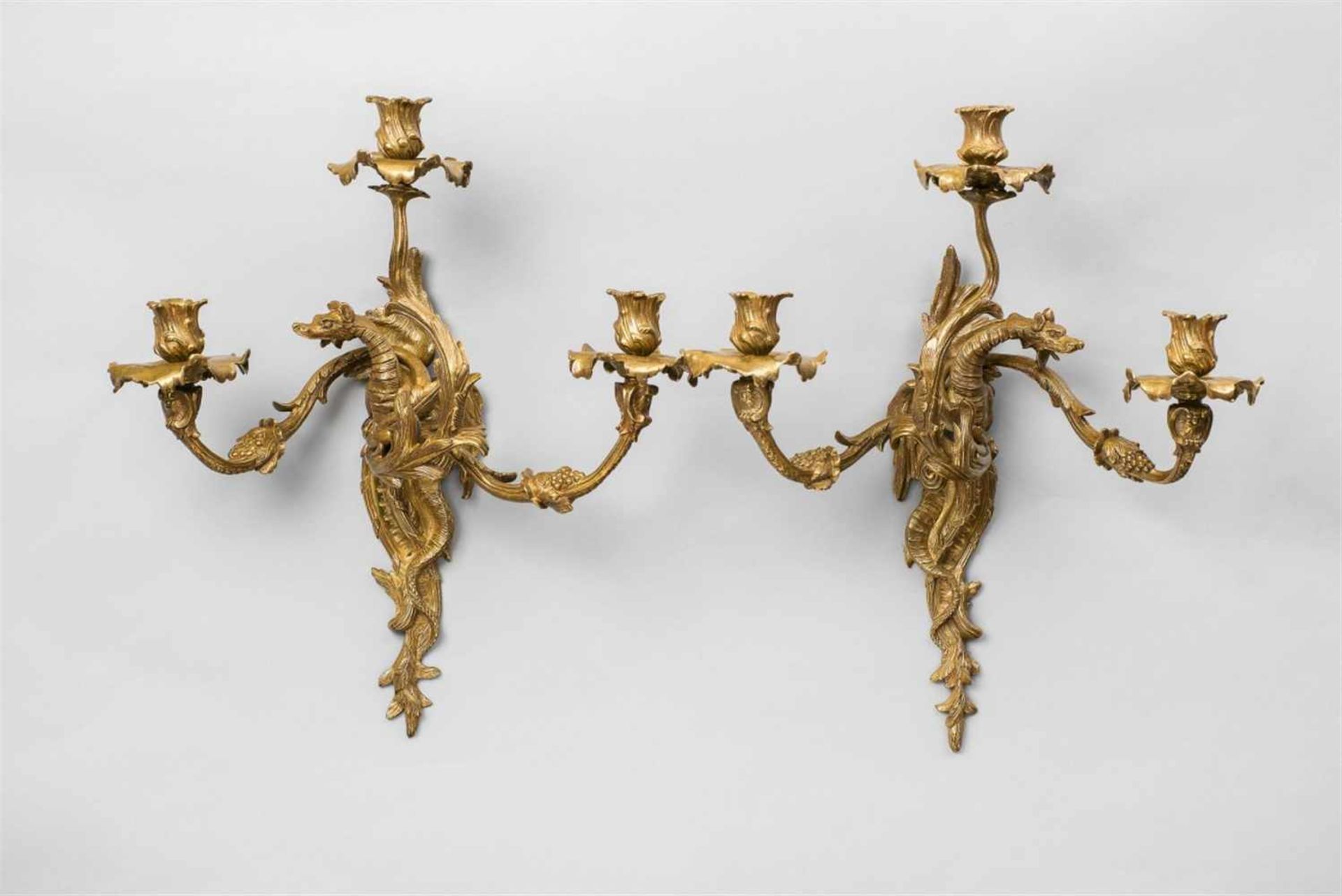 A pair of French ormolu appliques with dragonsThree-flame wall lights cast in several parts and