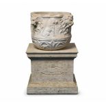 A white marble basin with four lion's headsDecorated with animal motifs including a lion and an