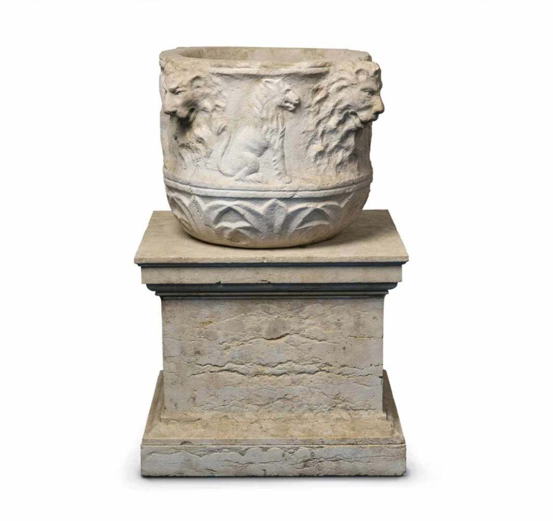 A white marble basin with four lion's headsDecorated with animal motifs including a lion and an