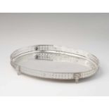 An Augsburg silver platterOval tray with pierced gallery rim resting on four supports. L 41.5; W 30;