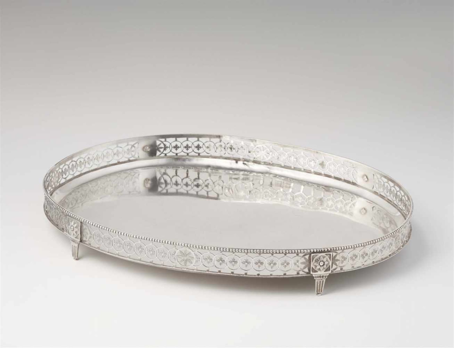 An Augsburg silver platterOval tray with pierced gallery rim resting on four supports. L 41.5; W 30;