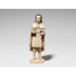 A carved ivory figure of a manWith remnants of polychromy and gilding. Figure of a man with curly