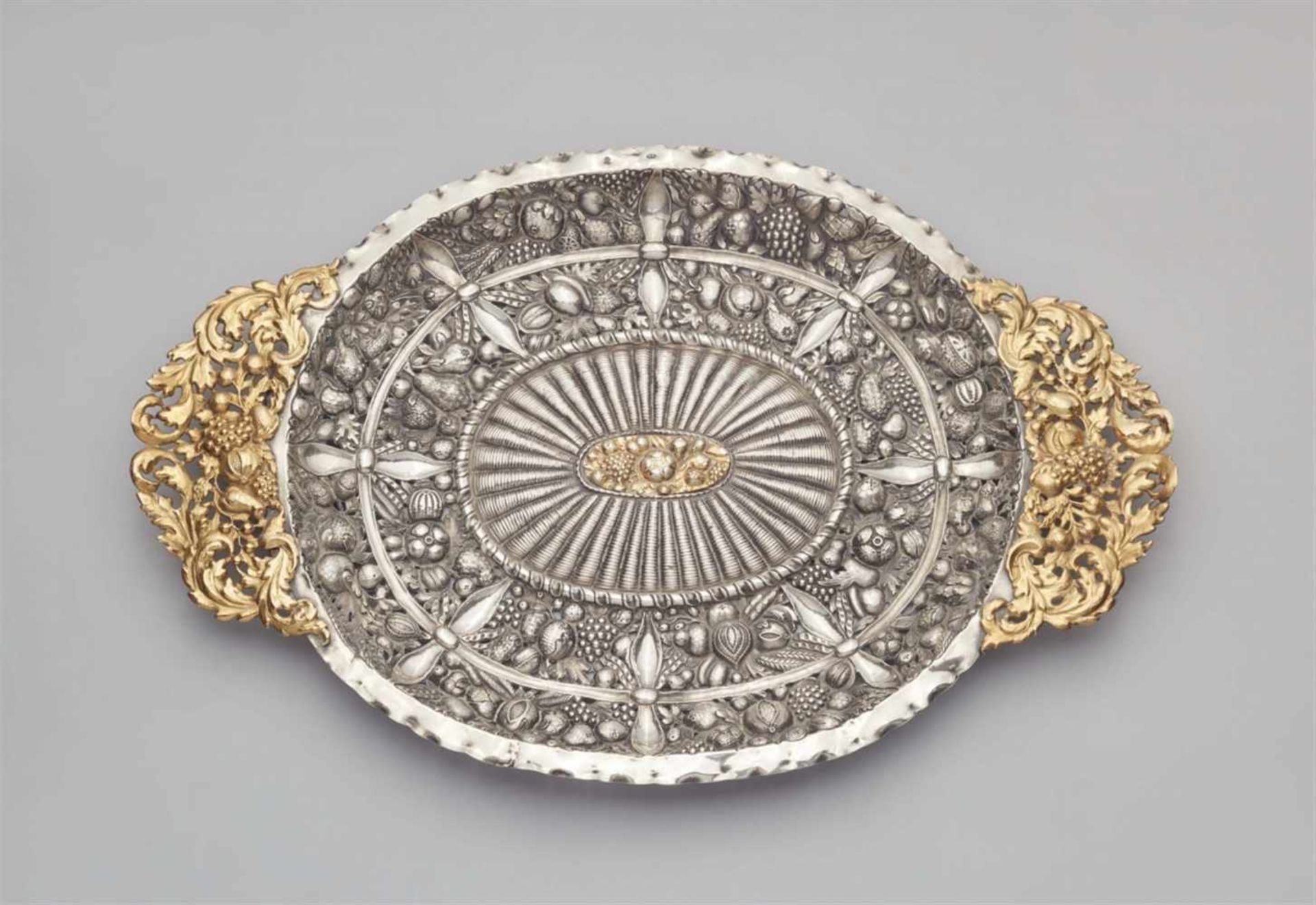 An Augsburg silver sideboard platterOval platter with pierced fruit garland handles, decorated to