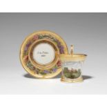 A Berlin KPM porcelain cup with architectural decorUnidentified model with scroll handle. With a