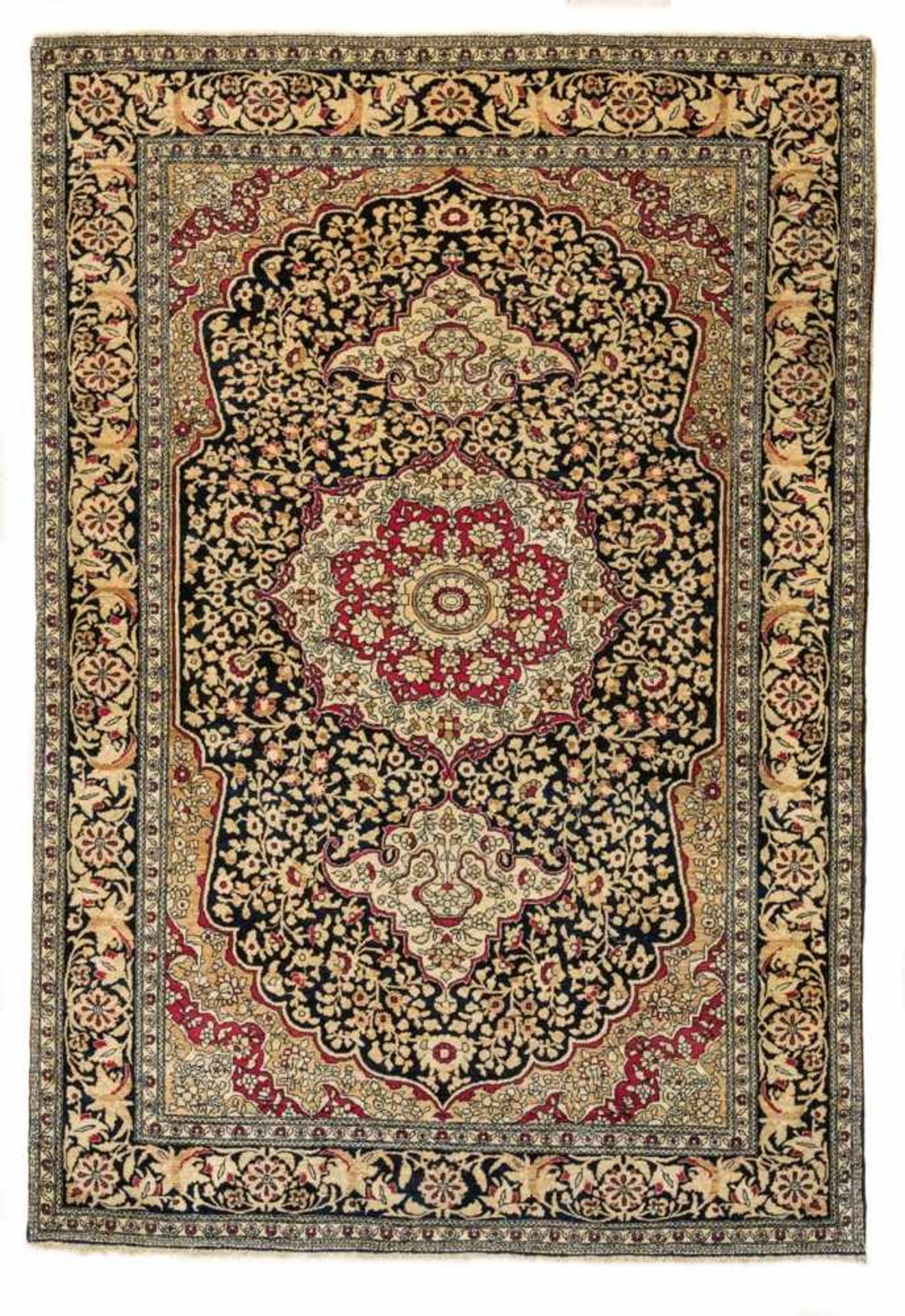 An Iranian Isfahan carpetWoll and cotton. With a medallion on dark blue ground. Slightly