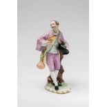 A Vienna porcelain figure of a gentleman as a pilgrimFigure of a shepherd on an earth mound base