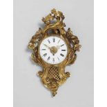 An ormolu Louis XV style cartel clockOrmolu clock with white enamel dial and black Latin numerals,
