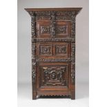 A Baroque carved oak cabinetThe surround richly carved with figures making music, winged angel's