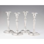 A set of four Augsburg silver candlesticksOval bases supporting fluted shafts and vase shaped