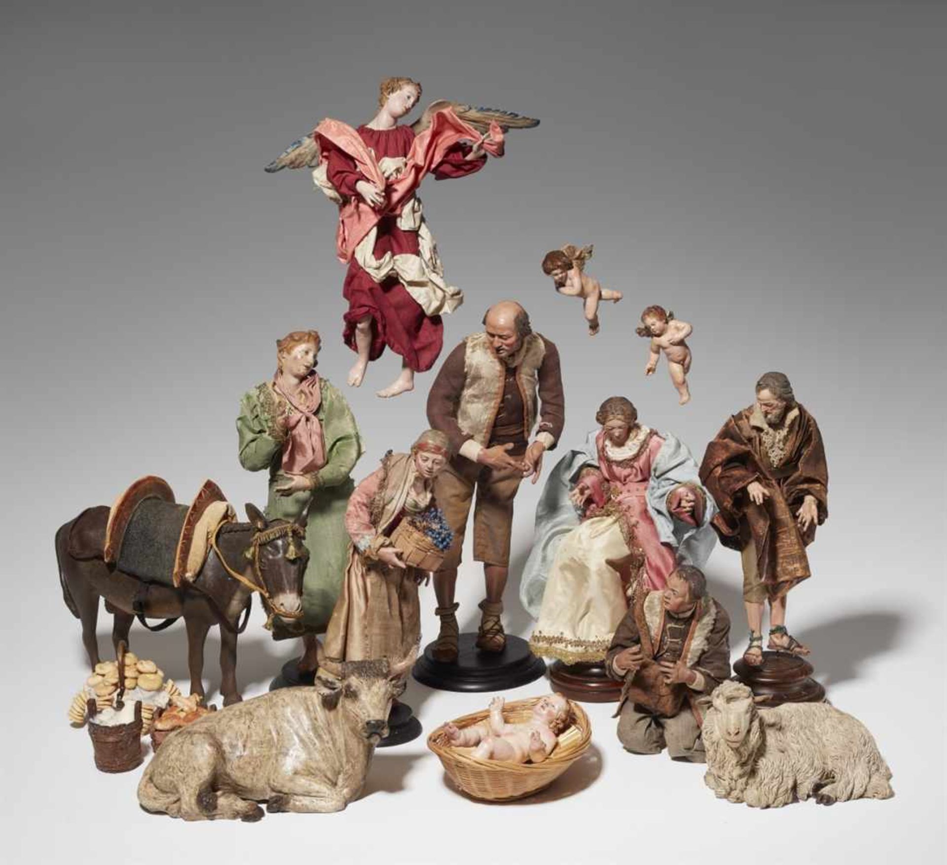 An extensive Neopolitan nativity scenePolychrome terracotta and wood figures with glass eyes, fabric
