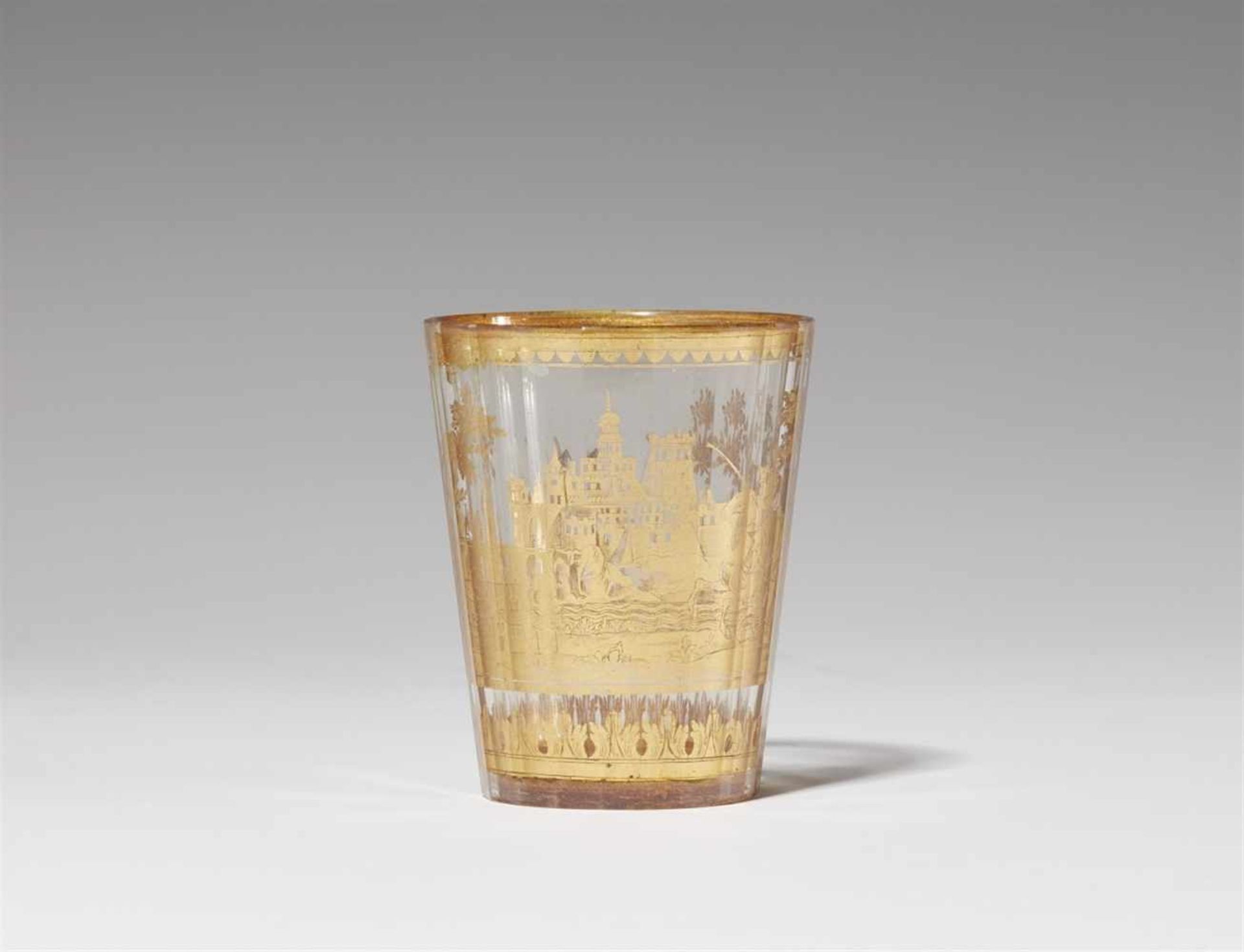 A Bohemian "zwischengoldglas" beaker with horsemenDecorated with a scene of horsemen by a harbour in