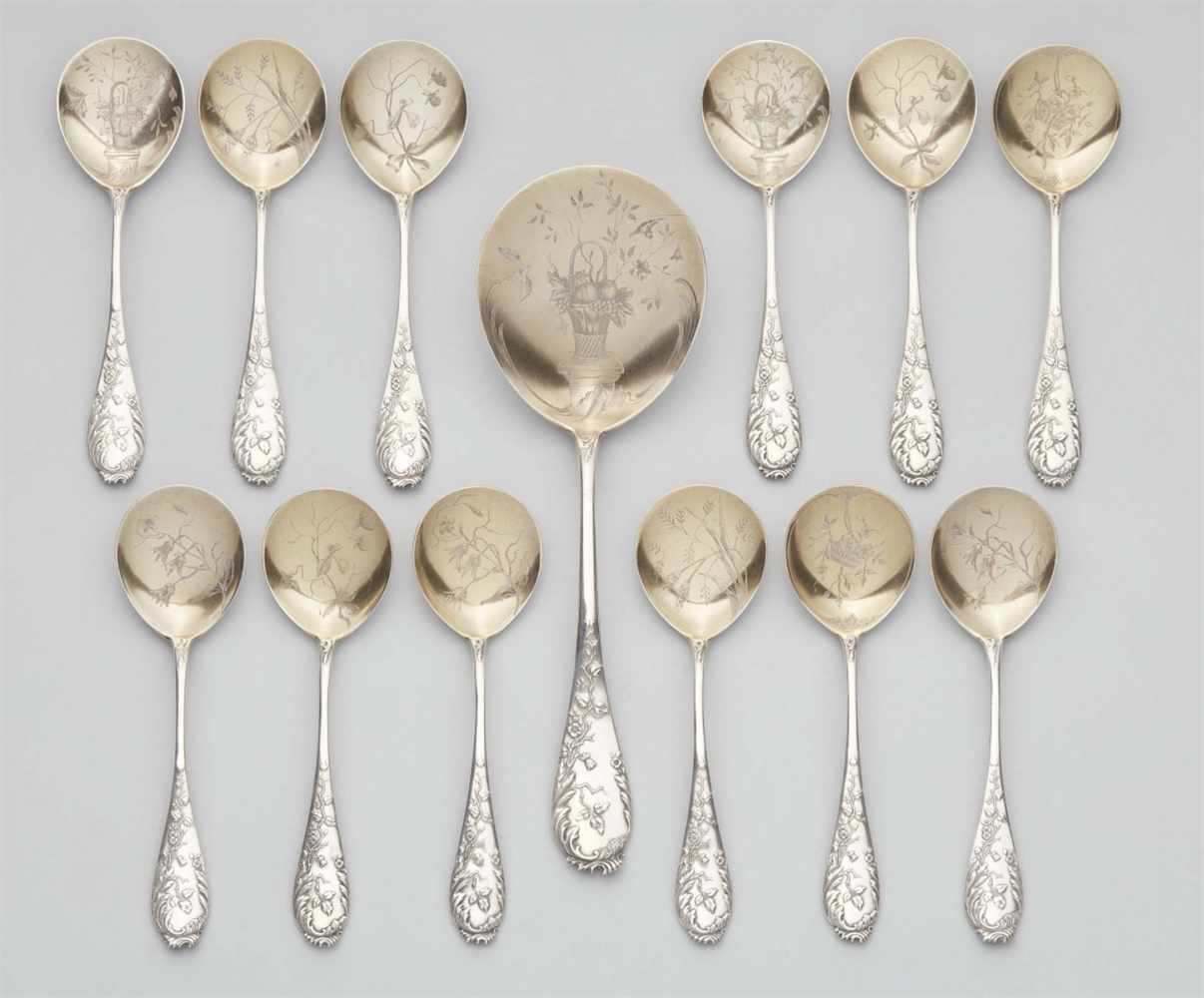 A Moscow parcel gilt silver ice cream cutlery setComprising 12 spoons and a large serving piece. The