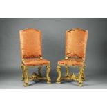 A pair of Roman carved walnut chairsWith later red damask upholstery. The gilding partially