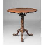 A George I style mahogany tripod tableLobed table top supported on turned and carved supports