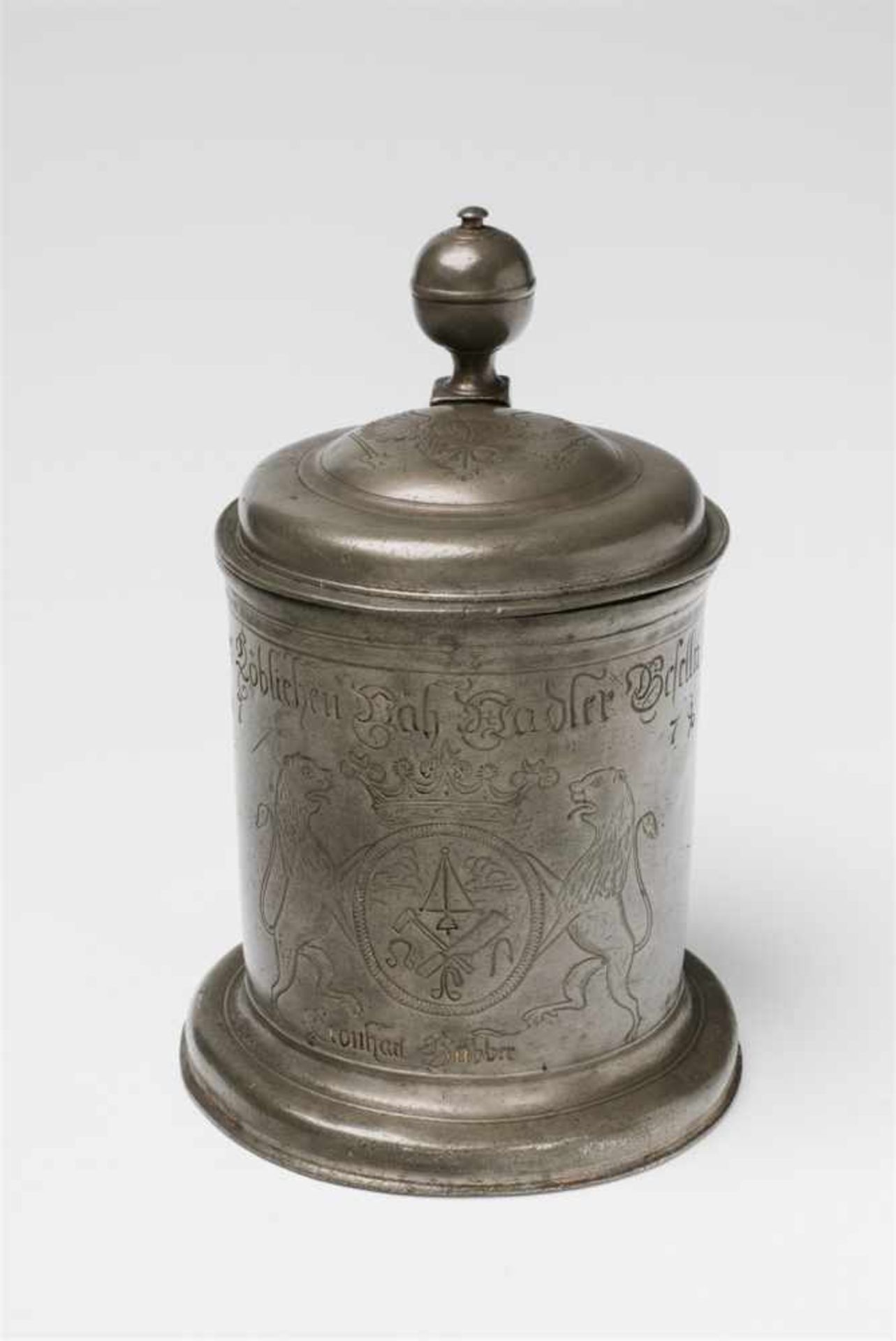 A Breslau tin guild tankardWith hinged lid, acorn shaped thumb rest and engraved imperial eagle.