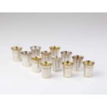 Twelve miniature silver beakersTapering interior gilt beakers with moulded rims. H 3.8 cm, weight of
