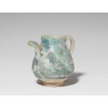 A small Iranian fritware pitcherQuarz frit with iridescent turquoise glaze. Restored. H 10.1 cm.