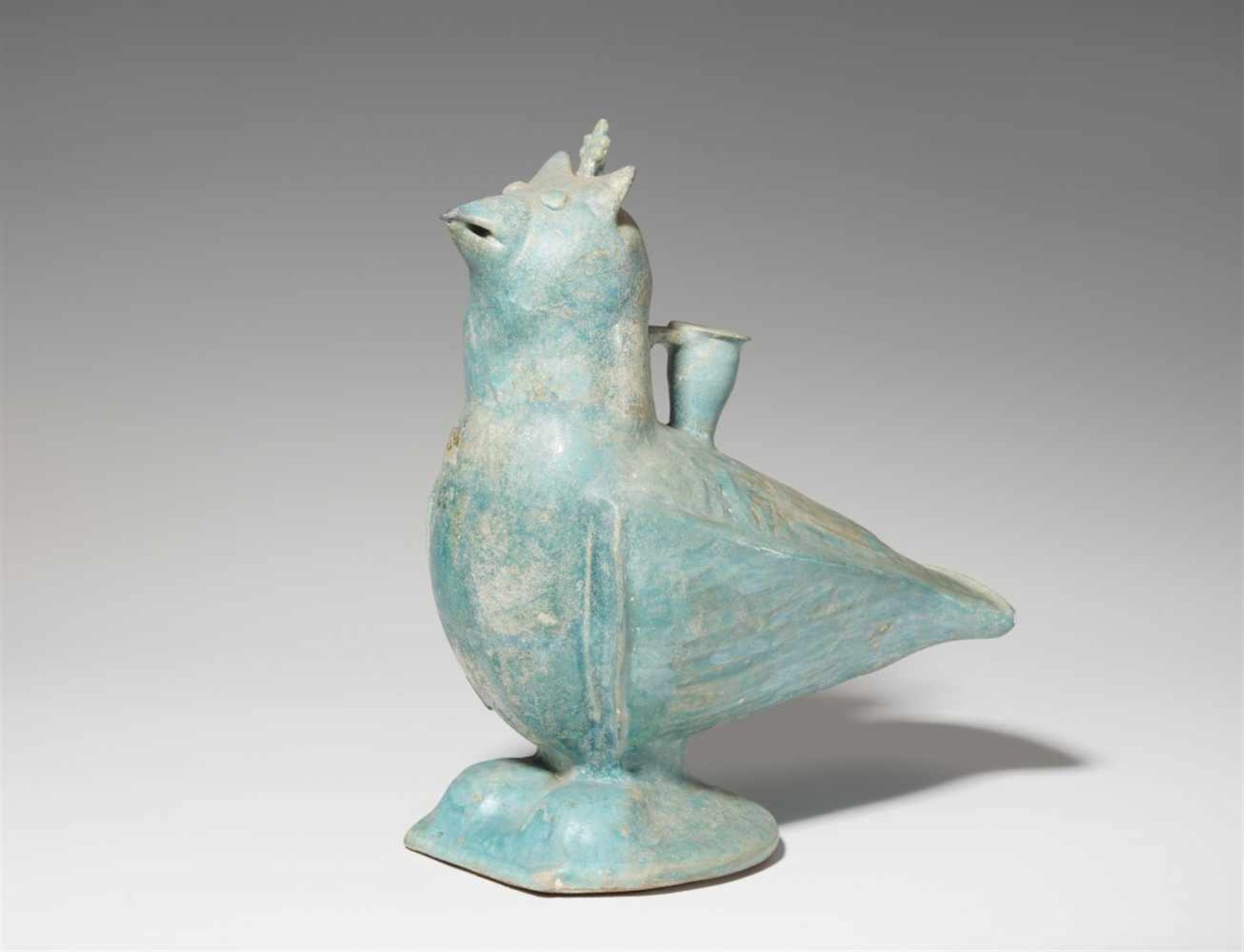 An Iranian fritware model of a birdQuarz frit incense burner with iridescent turquoise glaze. Formed