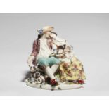 A Meissen porcelain pastoral groupA group depicting a shepherd and a shepherdess arm in arm on an