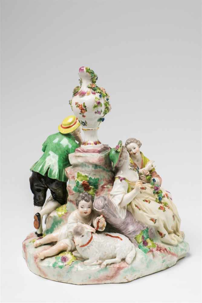 A Vienna porcelain shepherd groupFour figure group with a sheep and a ram surrounding a central