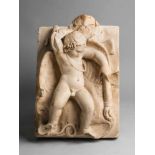 A Roman white marble relief of a Sleeping ErosDepicting a putto sleeping on outstretched wings