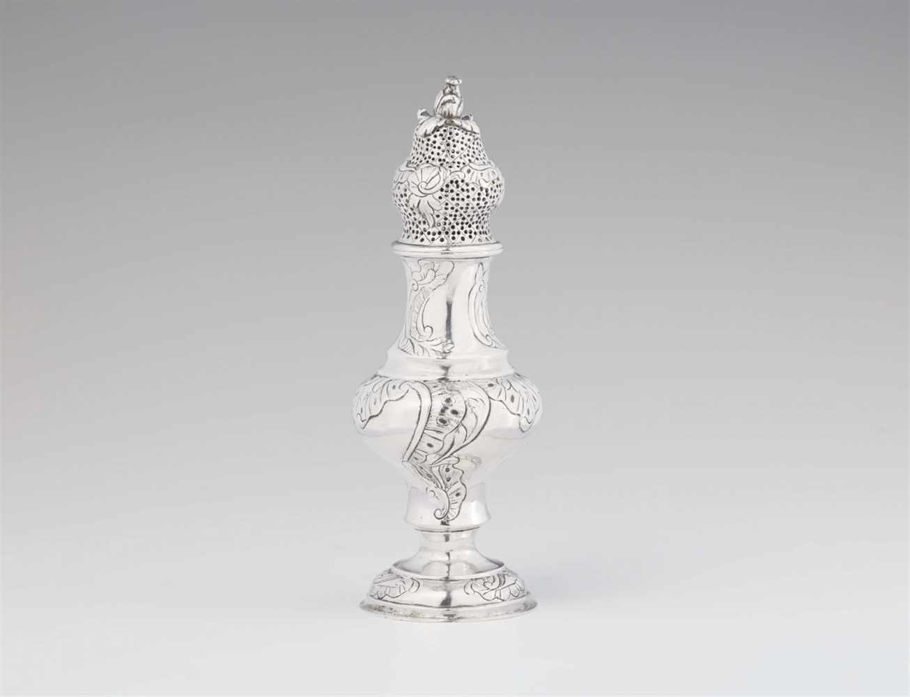 A Riga silver sugar casterOf slender baluster form with embossed shellwork and pierced upper section