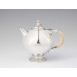 A Copenhagen silver teapot, no. 279Rounded teapot with ivory handle resting on a stepped foot with