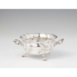 An Augsburg Rococo silver dishBombé form twist fluted dish with scroll handles resting on three
