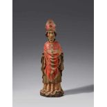 A Tyrolese carved wood figure of a bishop saint, circa 1400Carved in the round, the reverse only