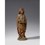 A late 15th century high relief figure of a Saint with a church model, probably AustrianCarved