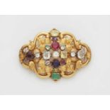 An 18k gold and coloured gemstone broochCast cartouche form brooch with chased floral relief. Set
