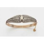 An 18k red gold bangle with rose-cut diamondsPierced hinged oval bangle set to the upper face with