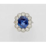 An 18k white gold Art Deco ring with a Ceylon sapphireCluster set with a fine untreated cushion-