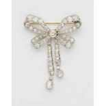 A Belle Epoque platinum bow broochMilligrain set with 65 old-cut diamonds (in total ca. 5.36 ct (M/