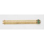 An 18k gold and Colombian emerald braceletDesigned as a flexible snake pattern band with fine