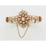 An 18k gold and diamond bangleDesigned as a pierced bangle with a Historicist rosette motif set with