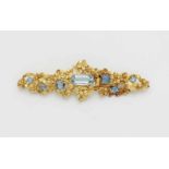 An 18k gold floral brooch with blue topaz18k gold brooch with red gold pin. Forget-me-not flowers