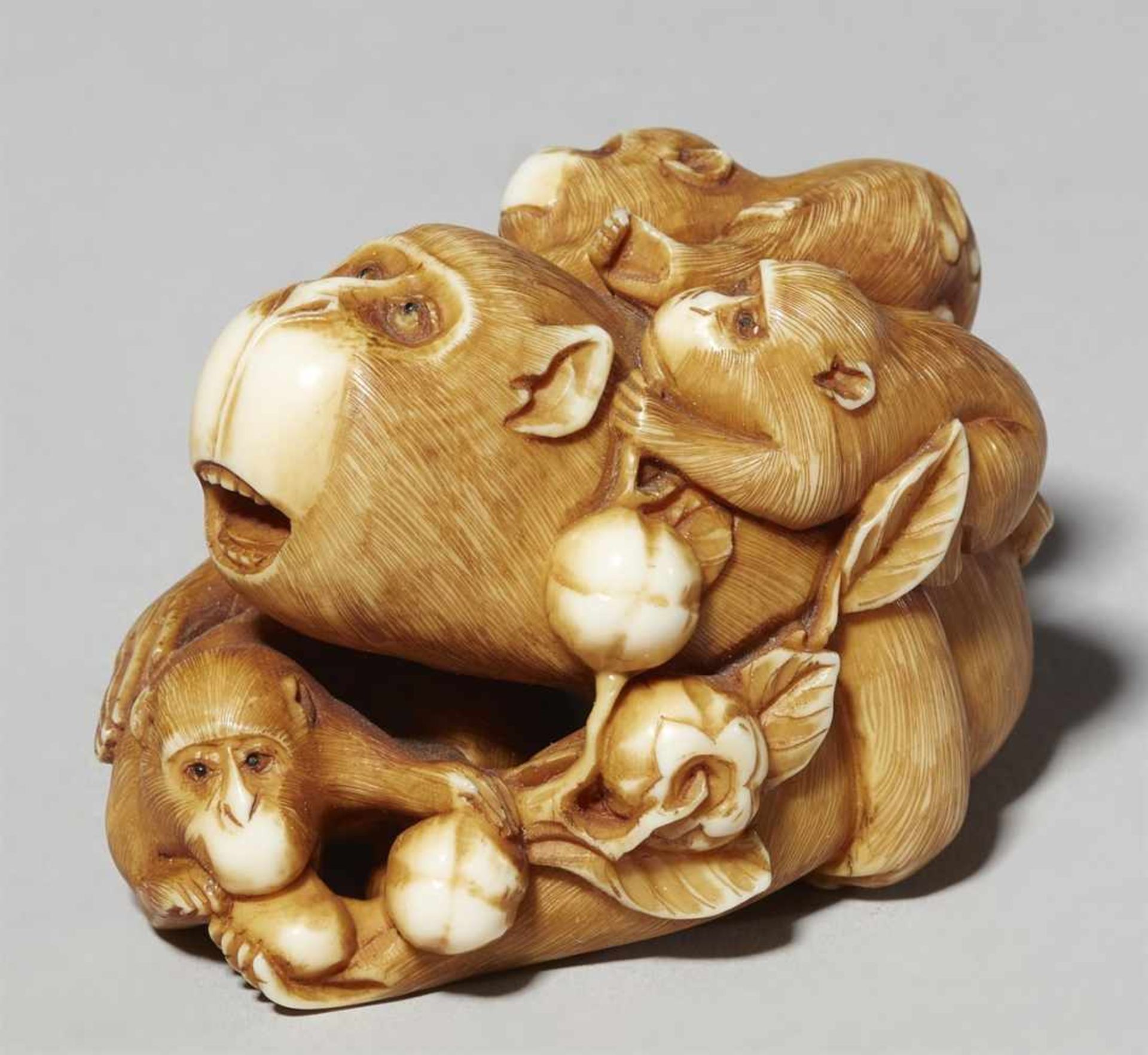 An ivory okimono of a monkey group. Late 19th century