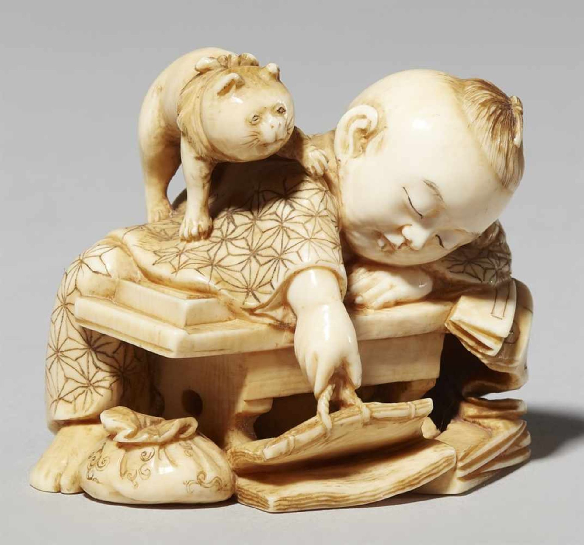 An ivory okimono of a sleeping boy. Late 19th century