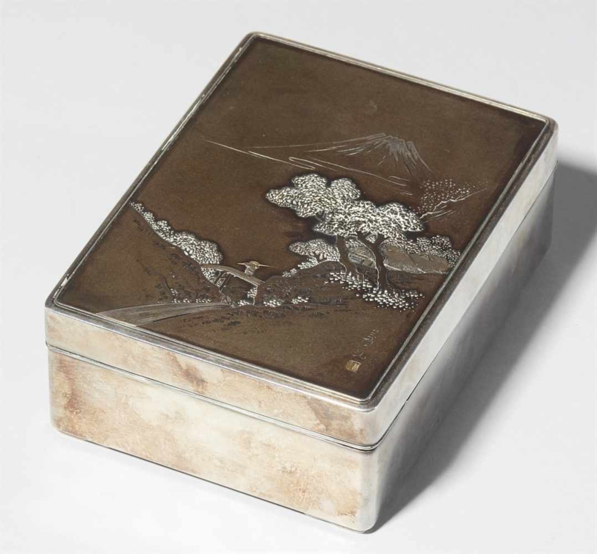 A silver and black-lacquered wood cigarette box. Around 1900