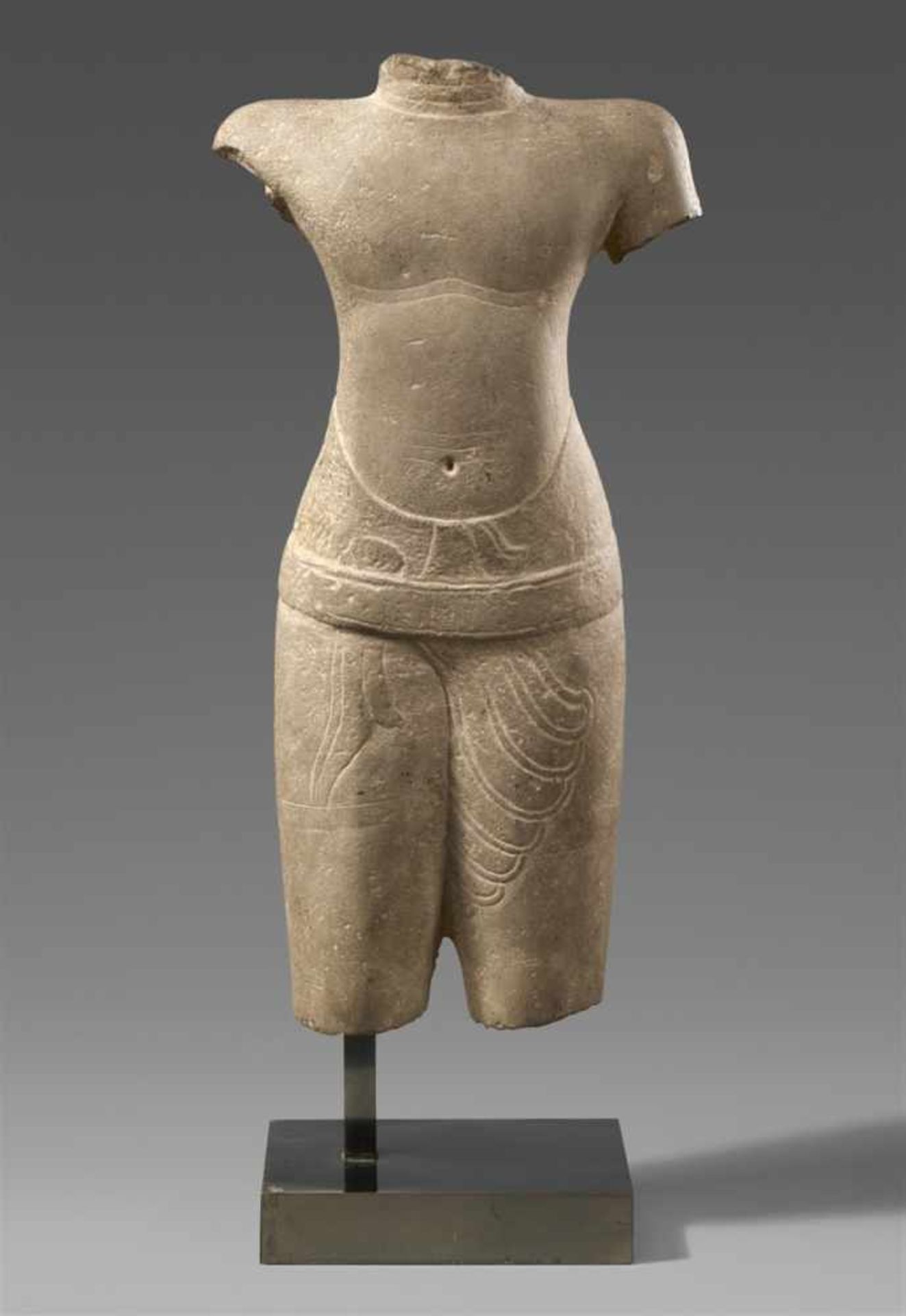 A Khmer male sandstone torso. Cambodia. Baphuon style. 11th century