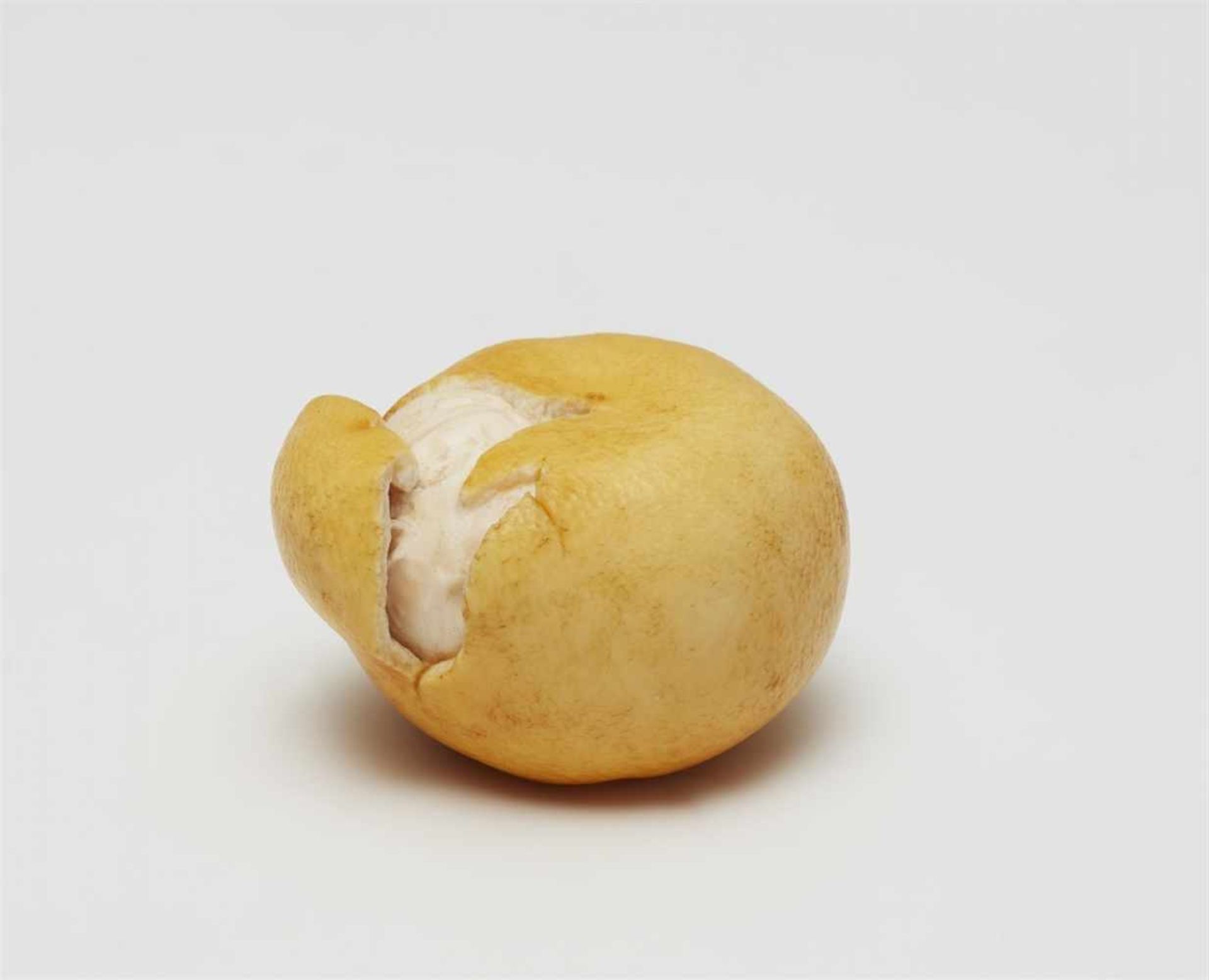 An ivory okimono in shape of a mikan. Early 20th century